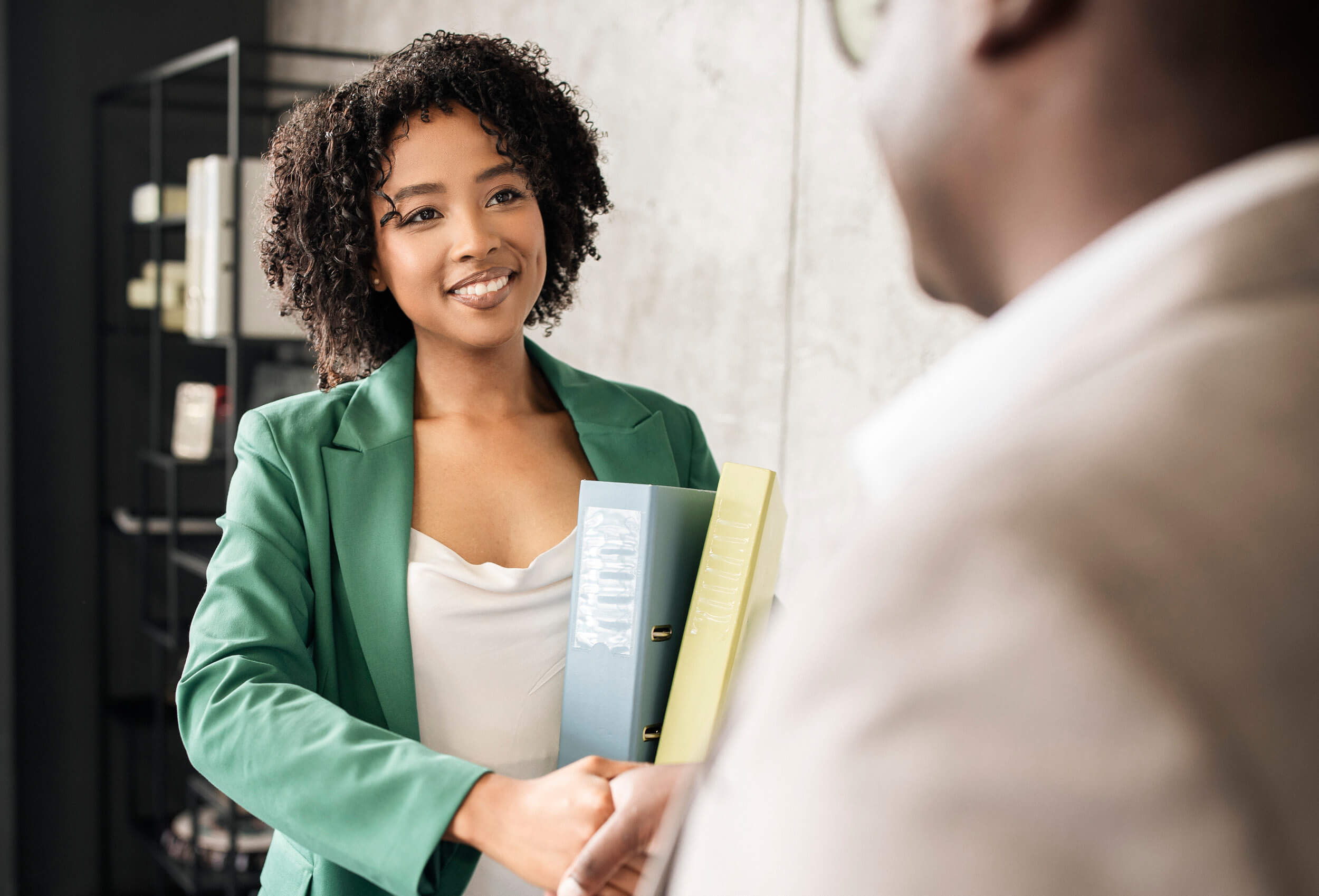 A prospective employee shaking hands during an interview.